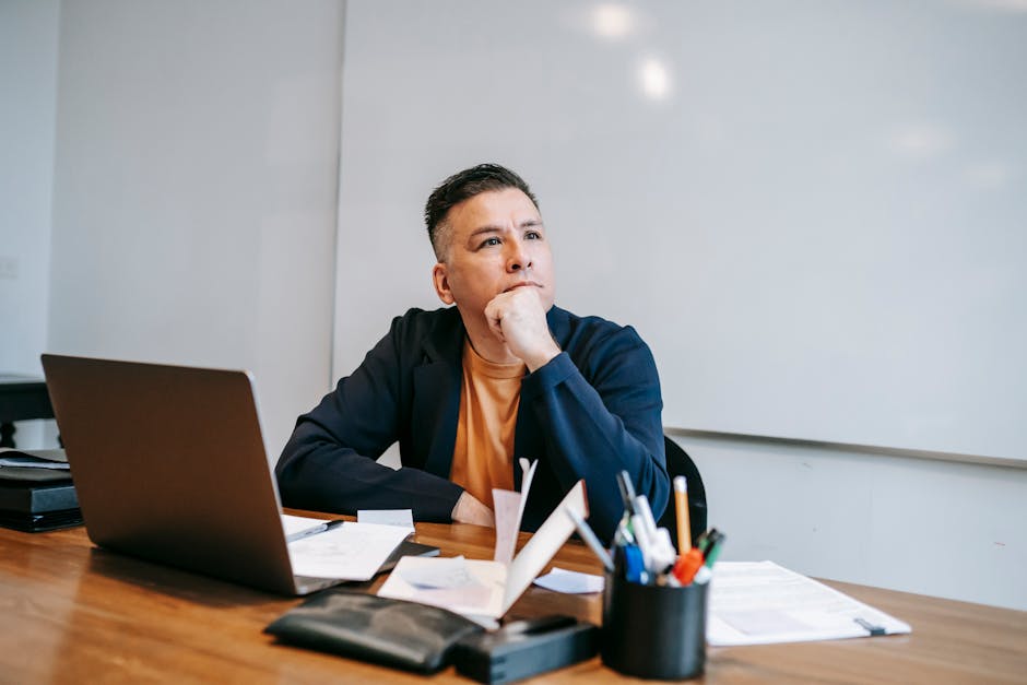 A person working intently at a desk with a calm expression